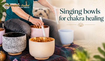 A crystal singing bowl set arranged for a daily chakra meditation practice