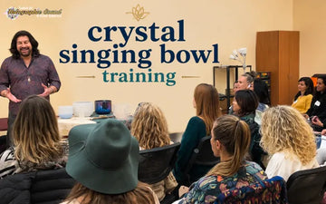 Practitioner playing a crystal singing bowl during a guided sound healing training session
